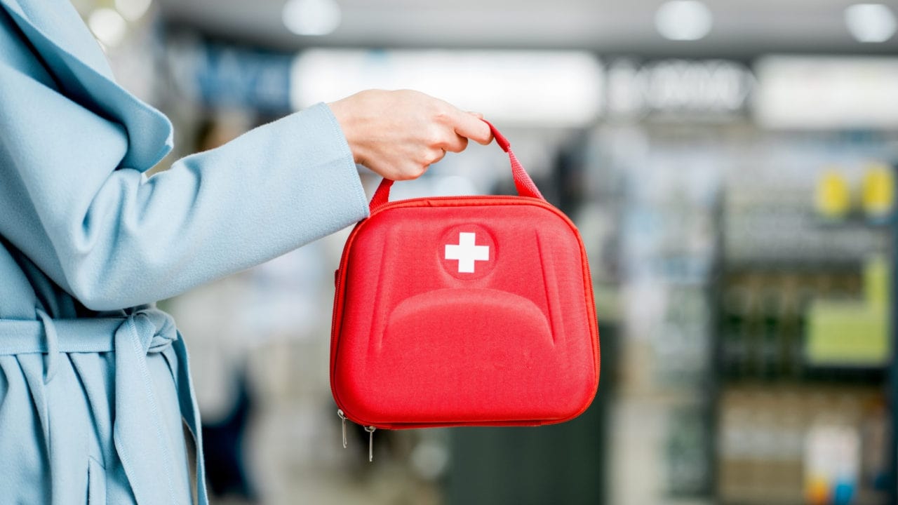 Person holding a first aid kit.