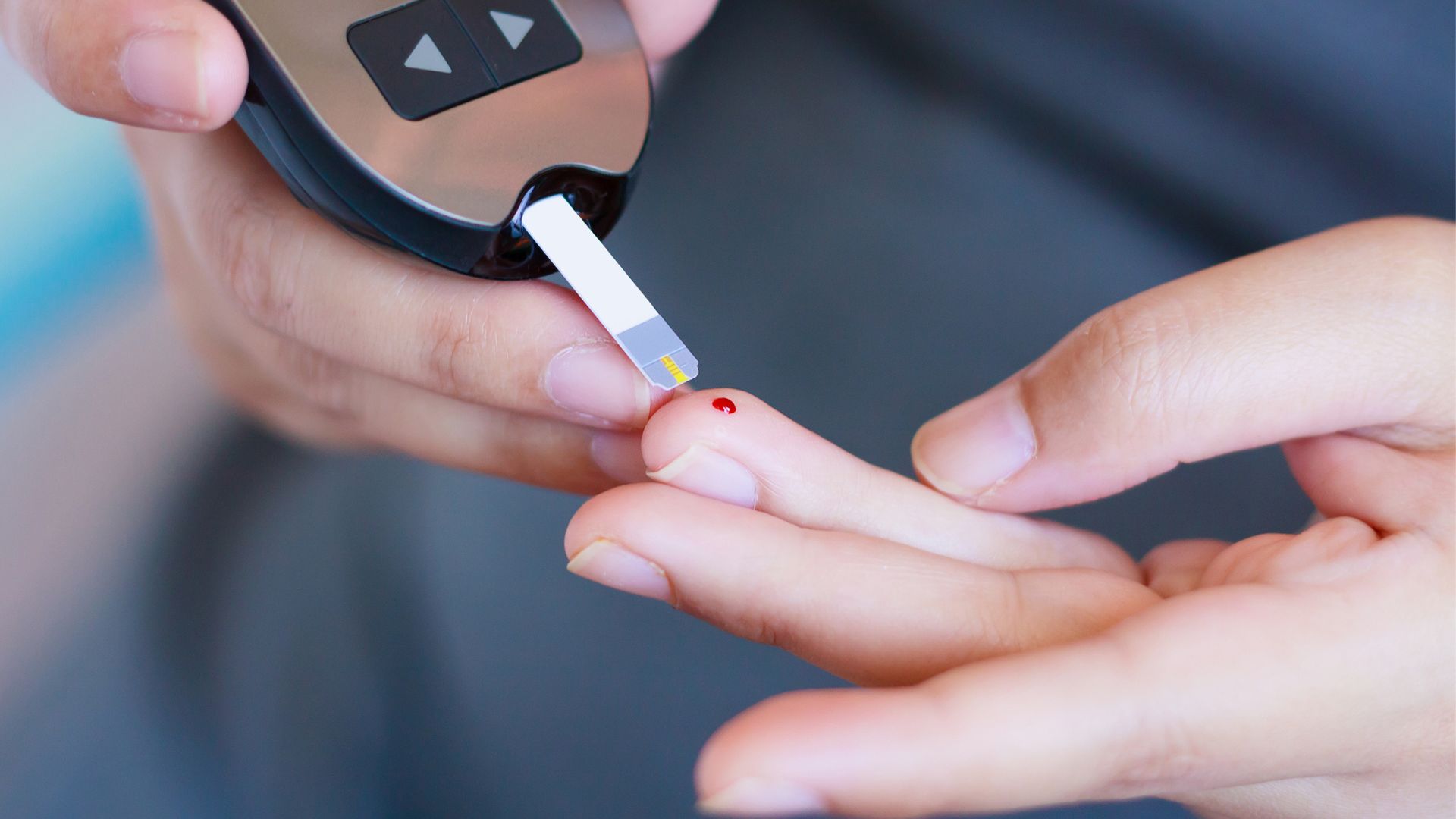 Someone checking their blood's sugar levels