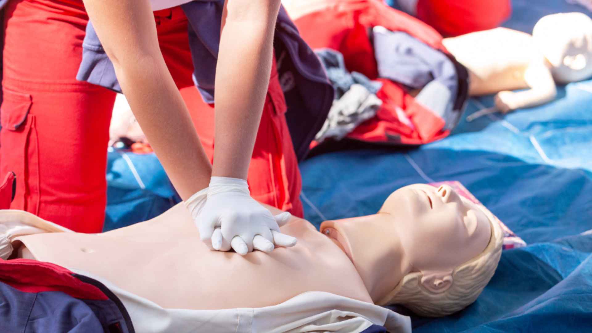 First Aid and CPR training session involving a person showing how CPR is performed.
