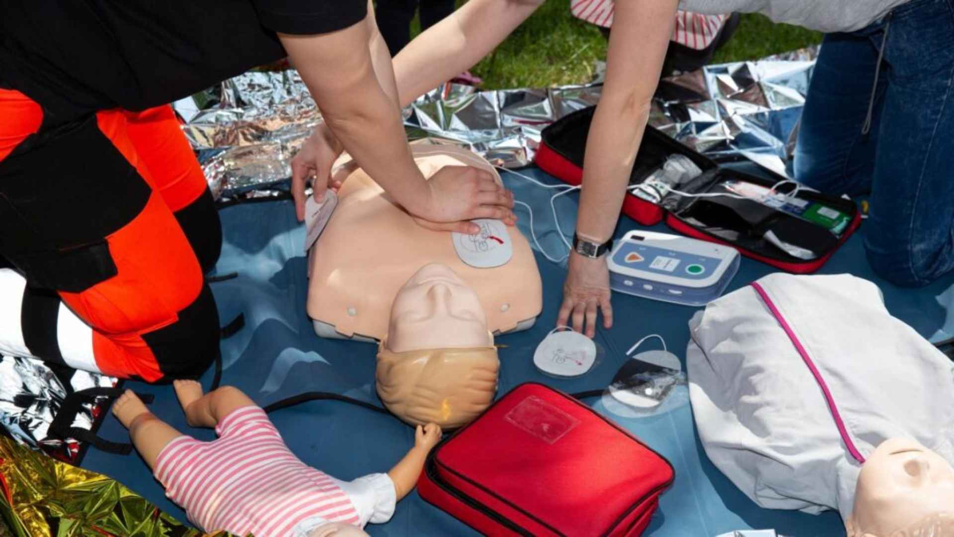 first aiders practicing on a mannequin with equipment