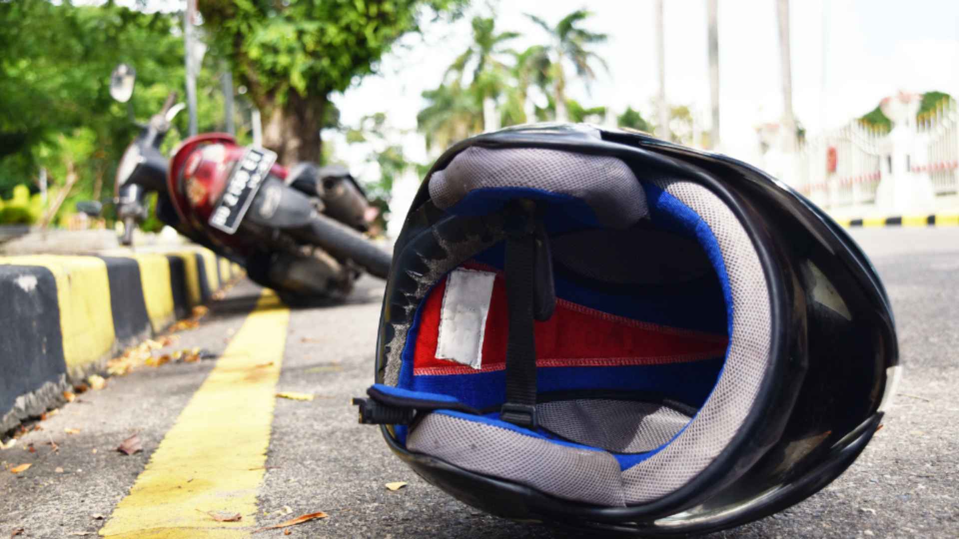 A bike and helmet lying on the road after a motorcycle accident.
