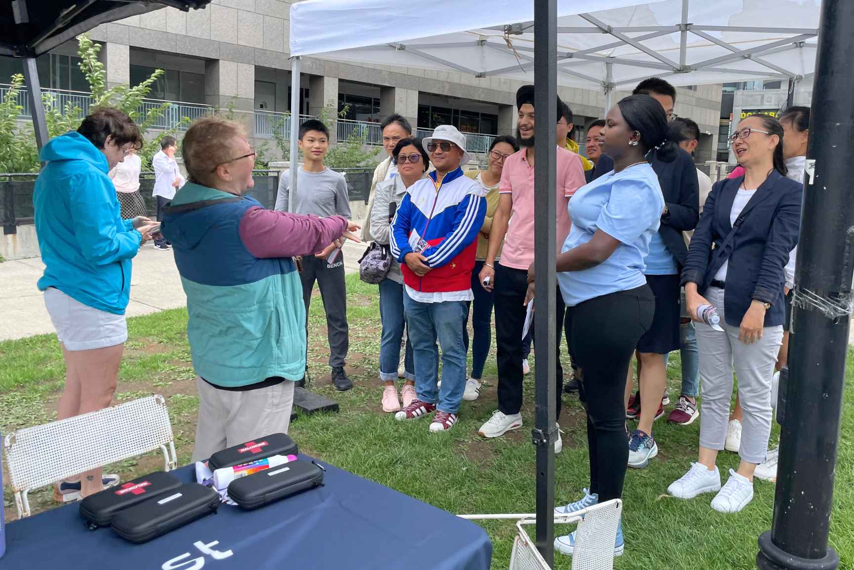 A group of people gathering and listening to a first aid training.