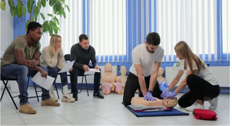 Instructor demonstrating AED pad placement during Coast2Coast first aid certification in Long Beach, CA