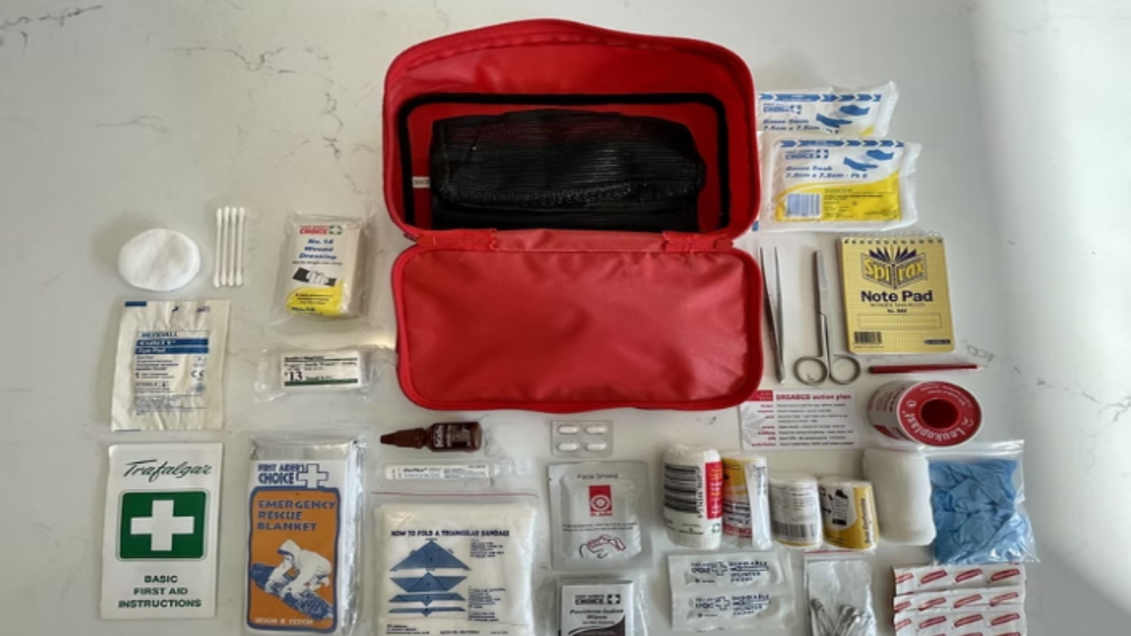 Coast2Coast recommended Canada Day first aid kit with bandages, burn cream, and CPR guide