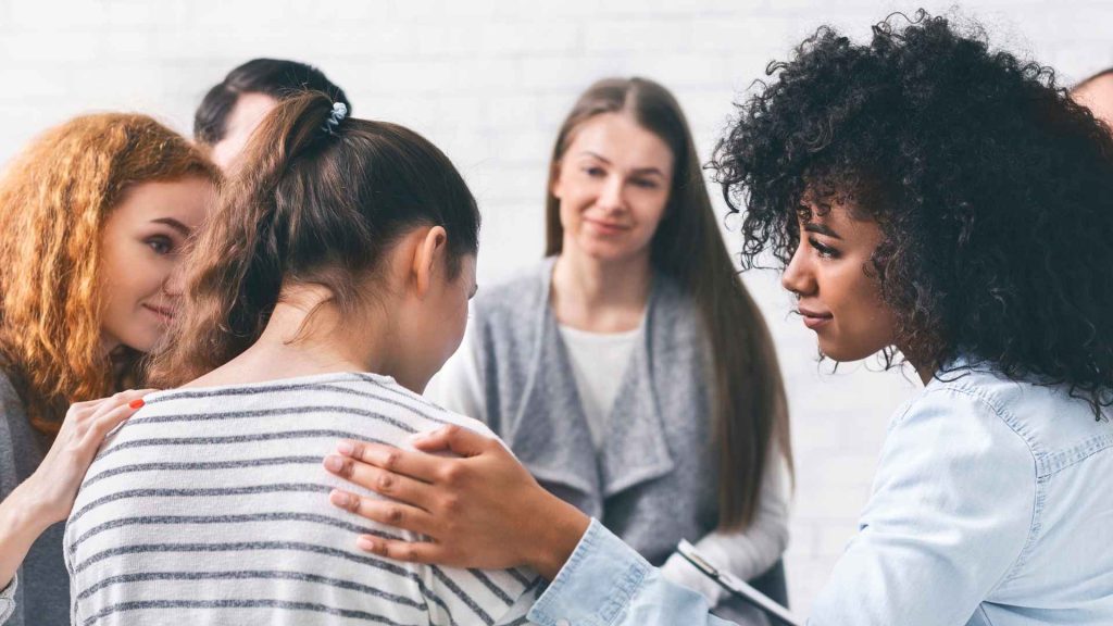 a small group of women supporting one woman