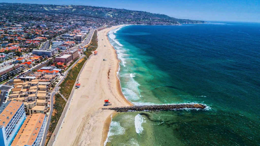 aerial view of long beach, california with buildings on the left and the ocean on the right