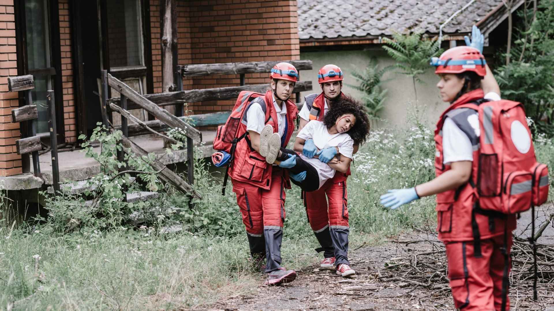 first aid responders carrying someone to safety